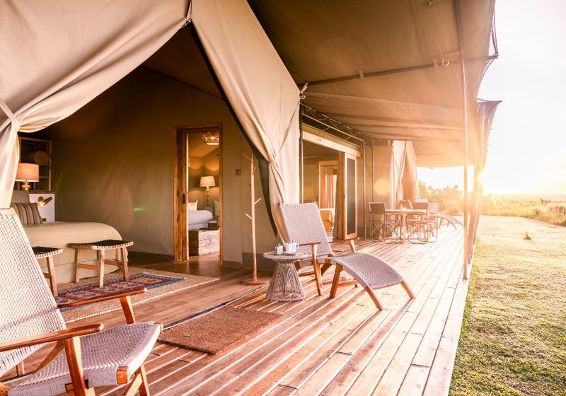 Luxury tented suite opening onto the savannah at sunrise